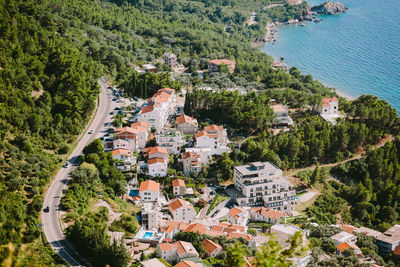 High angle view of townscape by sea against buildings