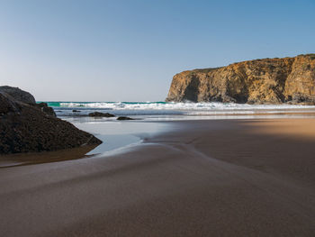 Scenic view of beach against clear sky