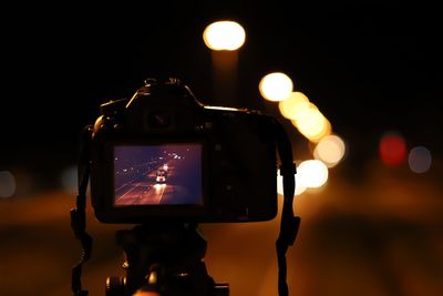 Close-up of camera on street at night