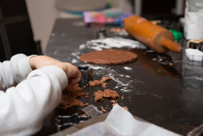 Cropped image of person preparing food on table