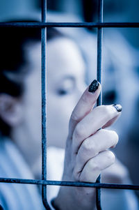 Close-up of hand holding cigarette