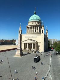 View of buildings in city against clear blue sky