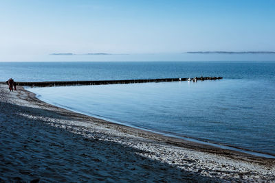 Scenic view of sea against blue sky