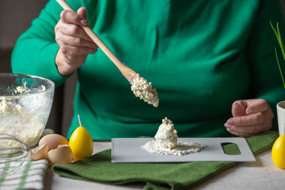 Midsection of man preparing food on table