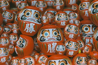 Full frame shot of pots with anthropomorphic face for sale at market