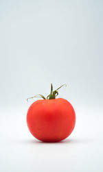 Close-up of tomato against white background