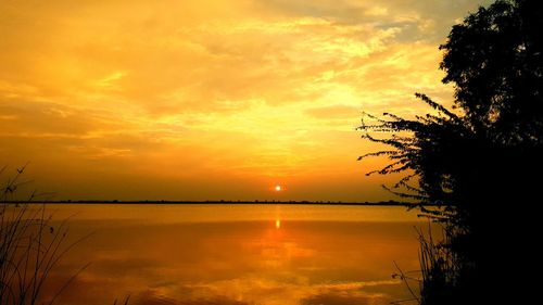 Scenic view of lake against romantic sky at sunset