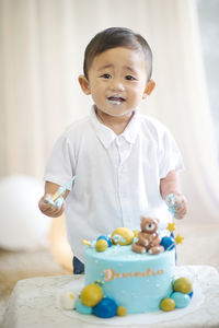 Portrait of cute boy eating cake