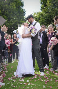 Couple holding bouquet of flowers