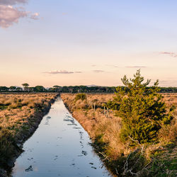 Scenic view of land against sky during sunset