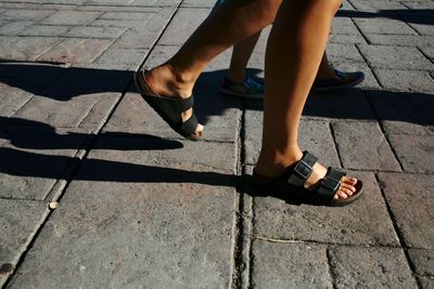 Low section of person walking on street