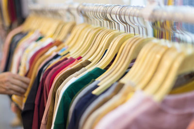 Close-up of t-shirts hanging at store for sale