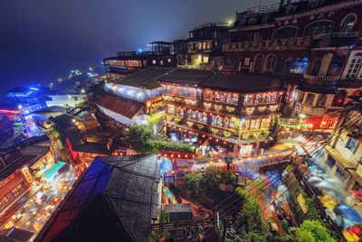 High angle view of buildings in city at night