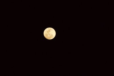 Low angle view of moon against clear sky at night