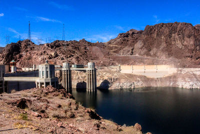 Scenic view of dam by lake against sky