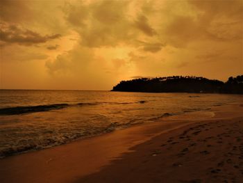 Scenic view of beach against sky during sunset