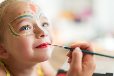 Close-up of girl with face paint at home