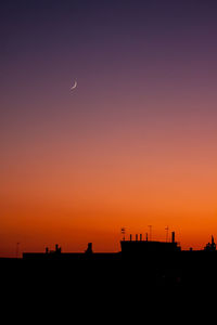 Scenic view of silhouette landscape against orange sky