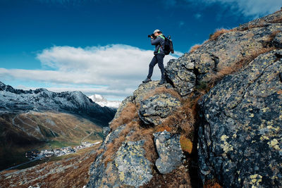 Man standing on rock against mountains