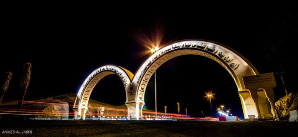 Low angle view of illuminated bridge at night