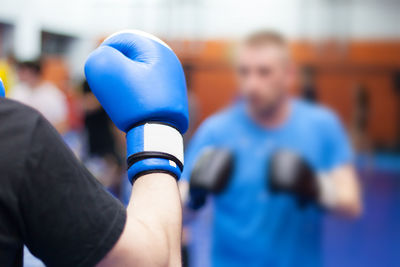 Close-up of man wearing boxing glove