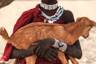 Midsection of man with dog outdoors