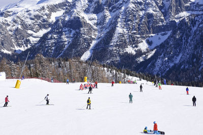 People skiing on snowcapped mountain