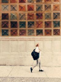 Full length of woman standing by railing