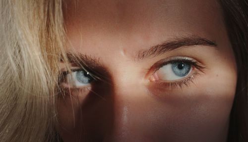 Close-up of woman with gray eyes looking away