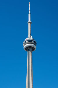 Low angle view of communications tower against blue sky