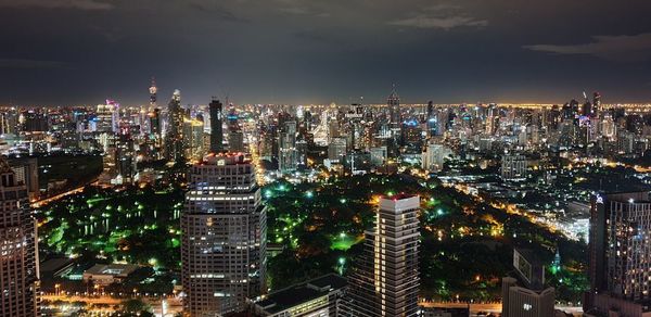 Illuminated cityscape against sky at night