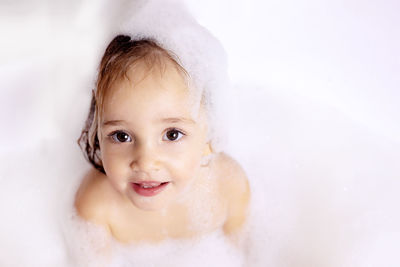 Close-up portrait of girl bathing at bathroom