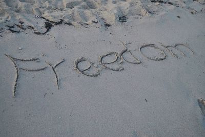 High angle view of text on sand at beach