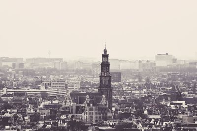 Aerial view of buildings in city against clear sky