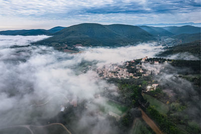 Panoramic view of the old village of mirmande. aerial photo in the morning in the thick fog rising 