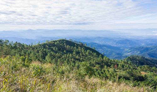 Scenic view of mountains against cloudy sky