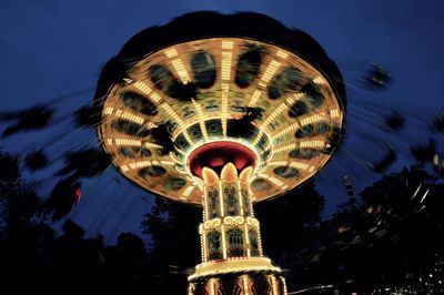 Low angle view of illuminated ferris wheel at night