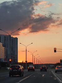 Traffic on road at sunset