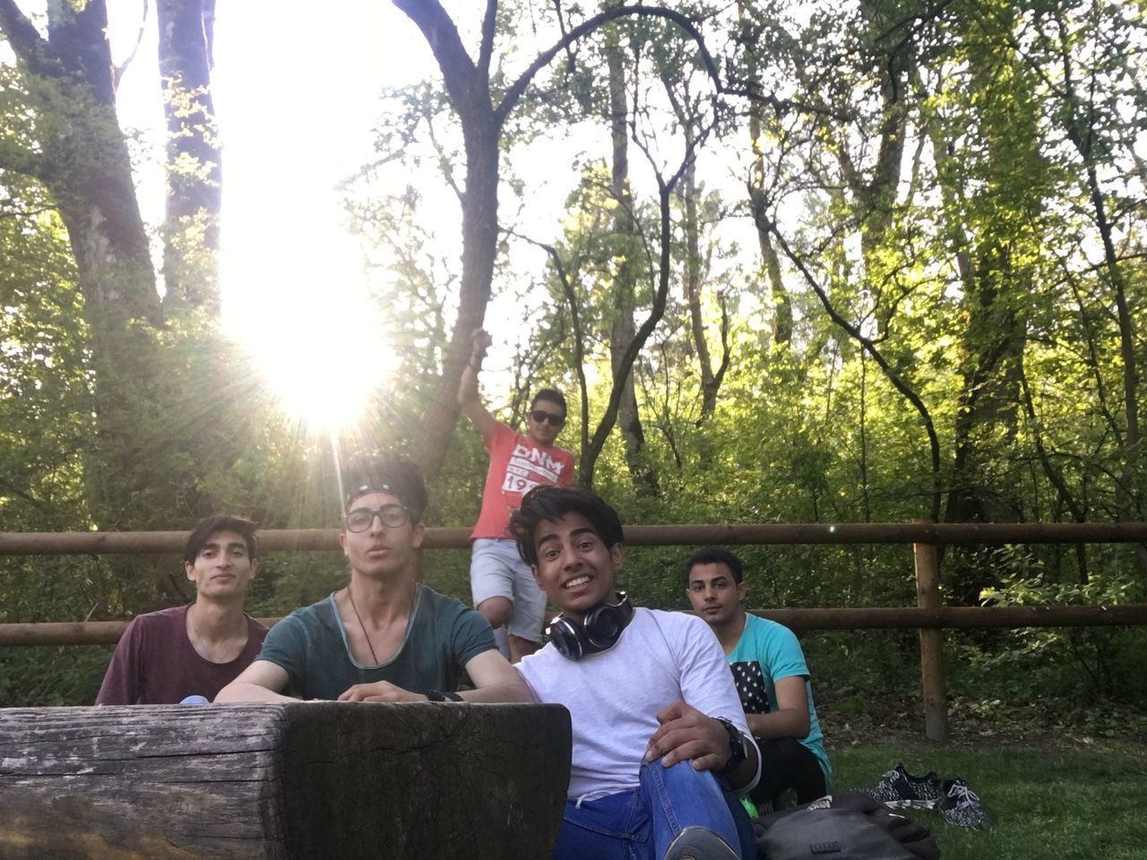 lifestyles, togetherness, leisure activity, bonding, person, love, casual clothing, young adult, smiling, happiness, childhood, friendship, family, portrait, boys, looking at camera, young men, tree