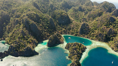 Aerial drone lagoons and coves with blue water among the rocks. palawan, philippines, busuanga