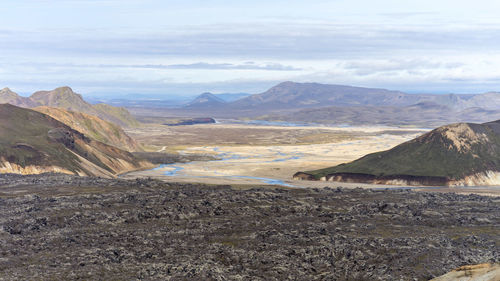 Iceland's volcanic black rock landscape with rivers and mossy hills