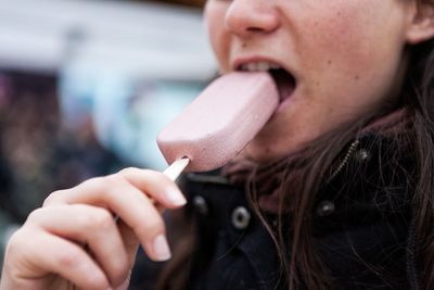 Close-up portrait of a woman eating icecream