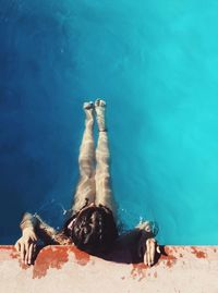 High angle view of young woman swimming in pool