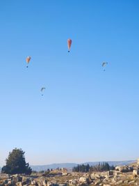 Low angle view of hot air balloon against clear blue sky