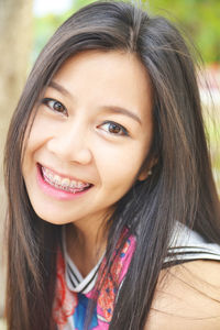 Close-up portrait of a smiling young woman