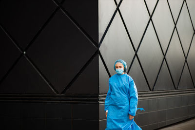 Portrait of man standing against wall