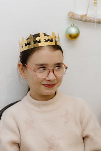 Portrait of a girl with a crown on her head after eating a royal galette.