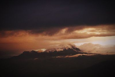 Scenic view of mountains against cloudy sky