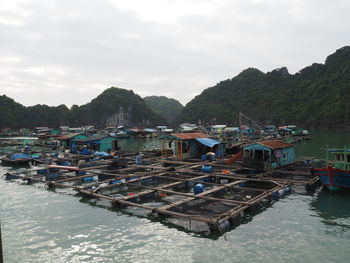 Lake with built structures against mountain range