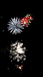 Low angle view of firework display at night